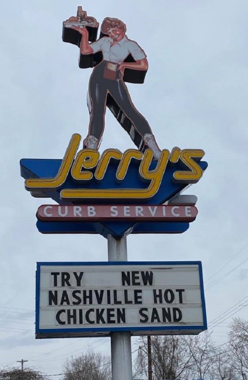 Sign for Jerry's Curb Service featuring a retro figure, promoting new Nashville hot chicken sandwich.