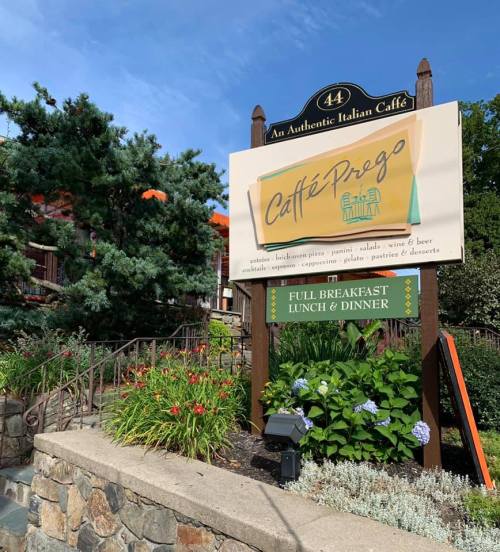 Sign for Caffé Prego, an authentic Italian café, featuring breakfast, lunch, dinner, and various menu items.