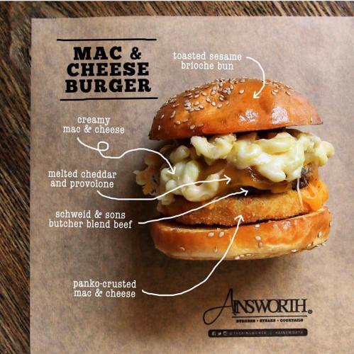 A mac and cheese burger on a toasted sesame brioche bun, layered with creamy mac and cheese and melted cheeses.