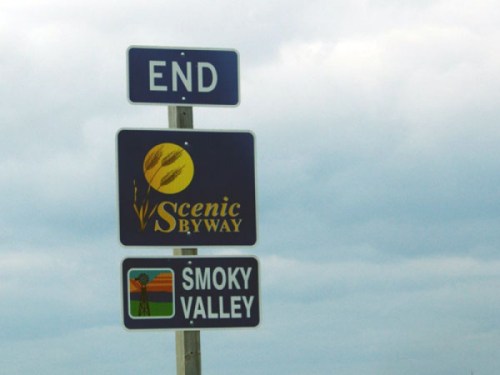 Signpost indicating the end of a scenic byway, featuring a logo and a Smoky Valley sign below it.