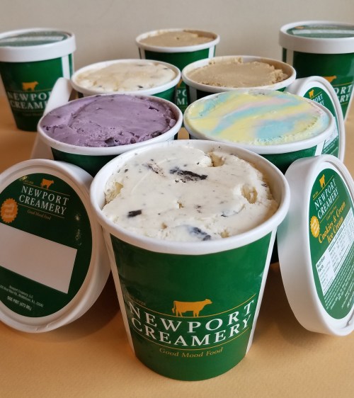 A variety of ice cream tubs from Newport Creamery, featuring different flavors and colorful labels.