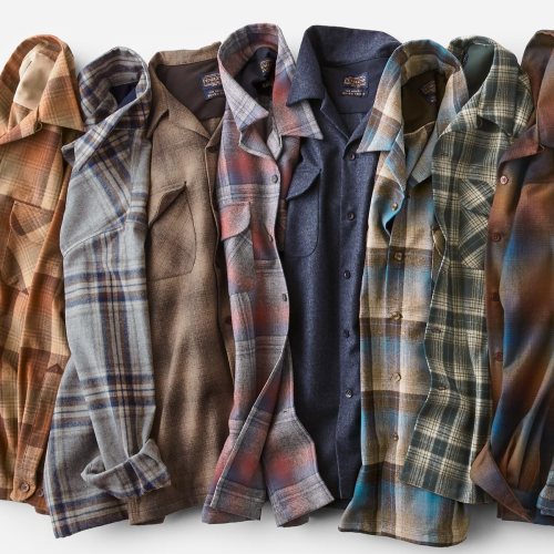 A collection of seven flannel shirts in various colors and patterns, arranged neatly.