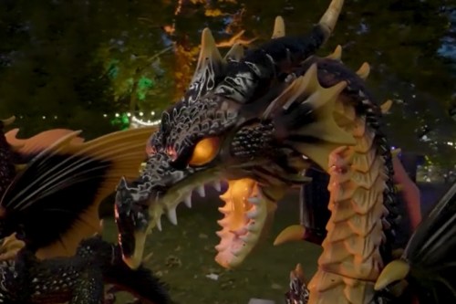 A detailed dragon sculpture with intricate scales, glowing eyes, and sharp teeth, set against a nighttime backdrop.