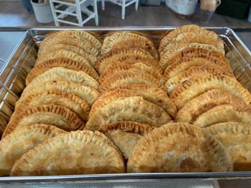 A tray filled with golden-brown, flaky pastries arranged neatly in rows.