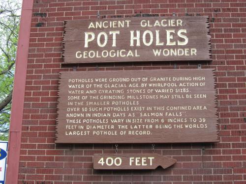 Sign about Ancient Glacier Pot Holes, describing their formation and size, located near a geological wonder. 400 feet noted.