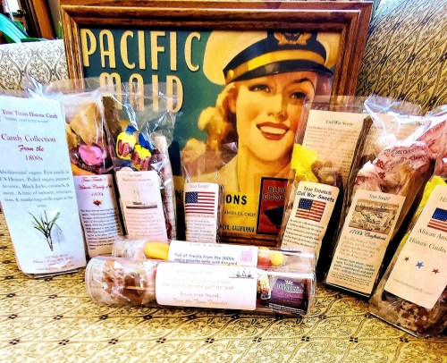 A vintage poster titled "Pacific Maid" surrounded by various candy packages and historical memorabilia.