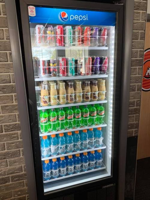 A vending machine filled with various Pepsi products, including sodas, energy drinks, and flavored waters.