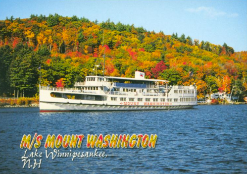 A vintage boat, M/S Mount Washington, sails on Lake Winnipesaukee, surrounded by colorful autumn foliage.