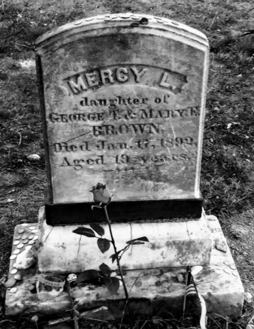 A weathered gravestone inscribed with "Mercy L., daughter of George & Mary E. Brown, died Jan 47, 1892, aged 19 years."