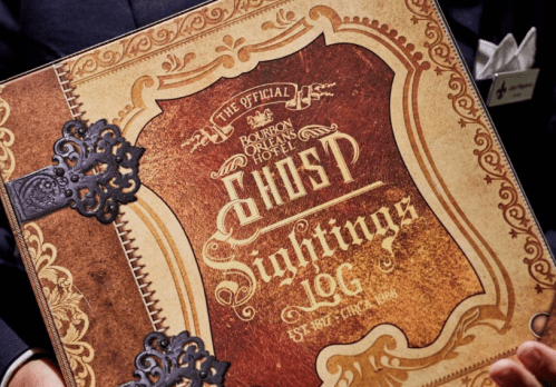 A decorative logbook titled "The Official Bourbon Orleans Hotel Ghost Sightings Log" with ornate design elements.
