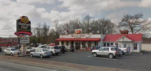 Exterior view of Bantam Chef Restaurant with a sign, cars parked, and a classic diner-style building.