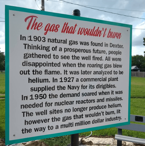 Sign about the history of natural gas in Dexter, highlighting helium's role and its impact on industry.