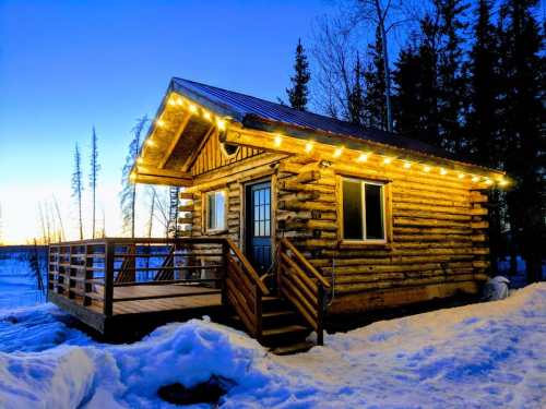 A cozy log cabin adorned with string lights, surrounded by snow and trees, under a twilight sky.
