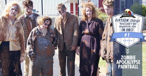 A group of six people dressed as zombies, covered in dirt and makeup, posing for a photo outdoors.