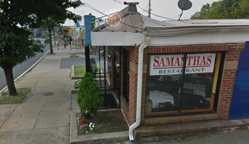 Exterior view of Samantha's Restaurant, featuring a brick facade and large windows, with a sidewalk and street nearby.