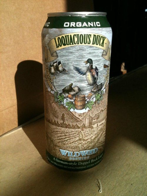 A can of Loquacious Duck Organic beer from Wildwood Brewing, featuring a detailed illustration of ducks and a landscape.