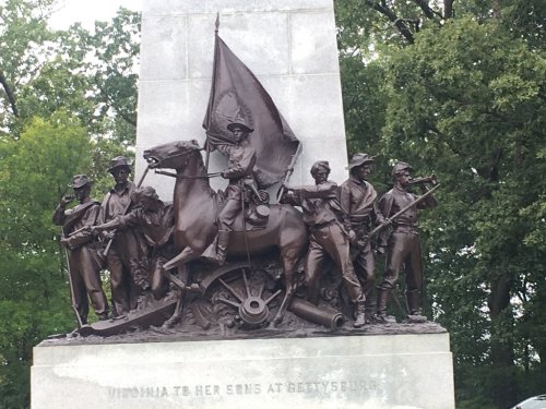 A bronze statue depicting soldiers and a horse, holding a flag, commemorating Virginia's role at Gettysburg.