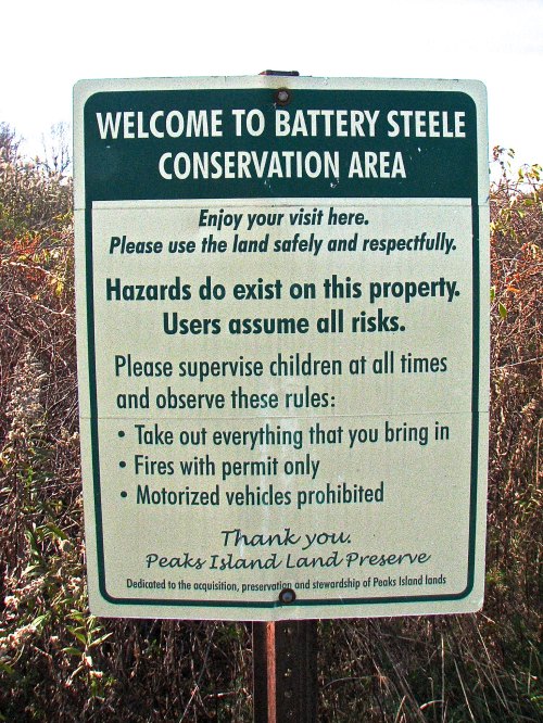 Sign at Battery Steele Conservation Area with safety guidelines and rules for visitors. Green background with white text.