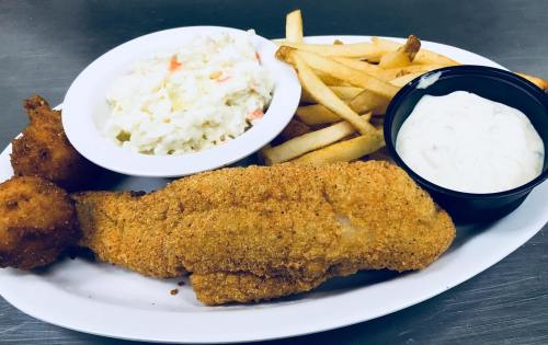 A plate of fried fish, coleslaw, French fries, hush puppies, and a side of tartar sauce.