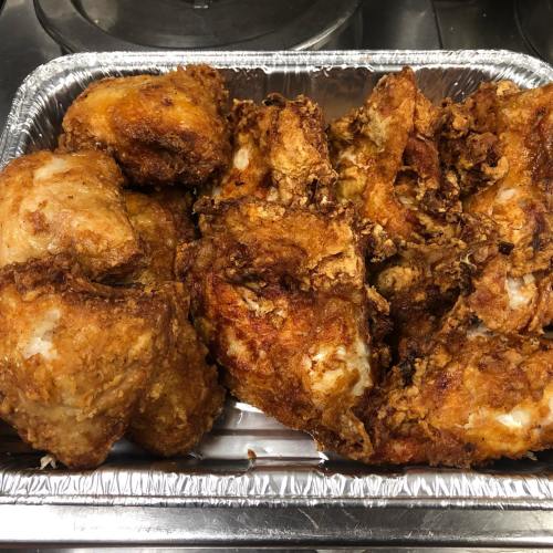 A tray of crispy, golden-brown fried chicken pieces arranged neatly.