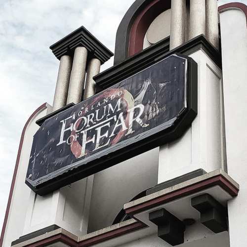 Sign for "Orlando Forum of Fear" displayed on a building, featuring a dark, eerie design.