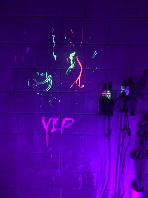 Graffiti on a purple wall featuring abstract designs and the word "YEP" in bright colors.