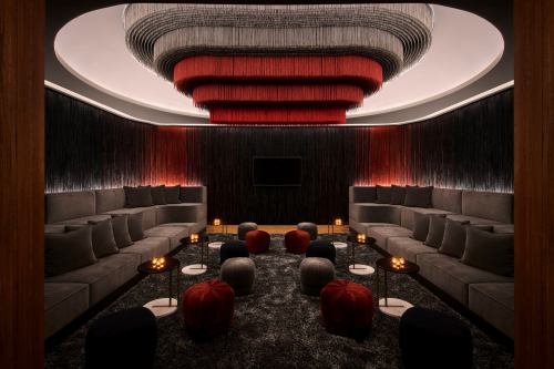 A stylish lounge with plush seating, ambient lighting, and decorative hanging elements in red and gray tones.