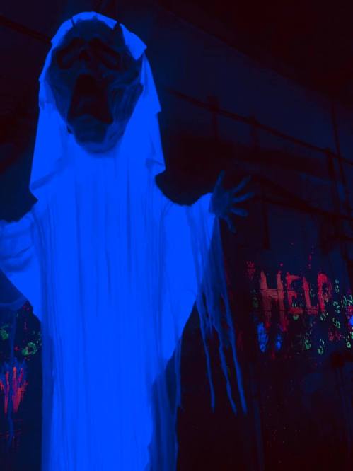 A ghostly figure in blue light with outstretched arms, set against a backdrop with the word "HELP" in vibrant colors.