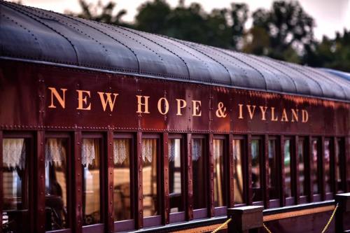 A close-up of a vintage train car with the words "New Hope & Ivyland" displayed prominently on the side.