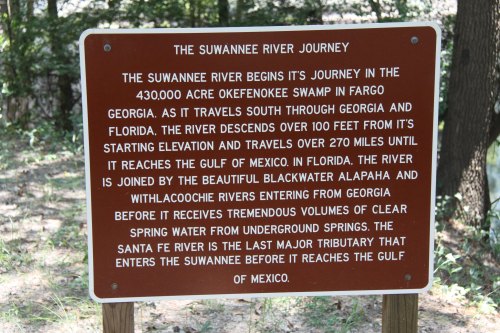 Sign about the Suwannee River's journey, detailing its origins, elevation changes, and connection to the Gulf of Mexico.