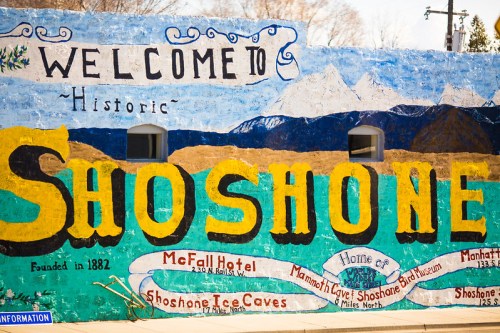 Colorful mural welcoming visitors to historic Shoshone, featuring local attractions and founding year.