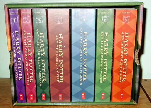 A box set of Harry Potter books, featuring all seven titles in colorful spines, neatly arranged in a green box.