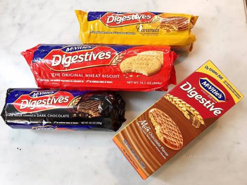 Four packs of McVitie's Digestives biscuits: original, caramel, dark chocolate, and milk chocolate flavor.