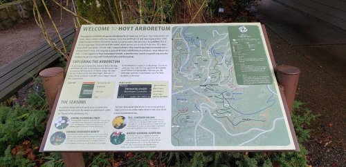 Sign at Hoyt Arboretum with a map and information about exploring the arboretum and its seasonal features.