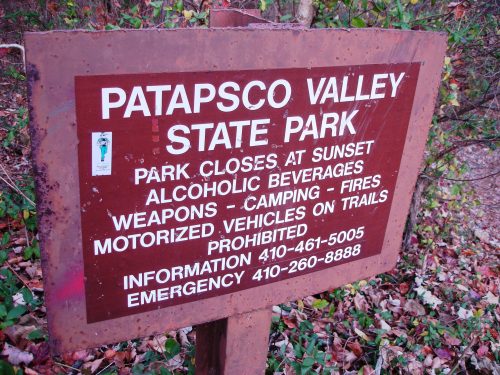 Sign for Patapsco Valley State Park with rules about park hours, prohibited items, and contact information.