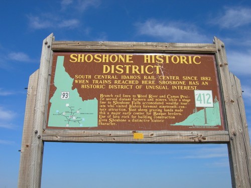 Sign for Shoshone Historic District in Idaho, highlighting its history as a rail center since 1882 and local attractions.
