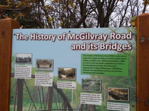 Sign about the history of McGilvray Road and its bridges, featuring images and text on preservation efforts.