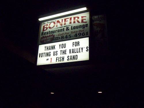 Sign for Bonfire Restaurant & Lounge thanking customers for voting them the Valley's #1 fish sandwich.