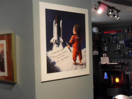 A child in a space suit gazes at a rocket, with the quote, "It may be today, this year, or next. Do the next."