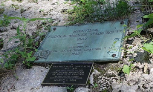 Plaque marking the Millville Frink & Walker Stage Route, established in 1837, with historical details and registration date.