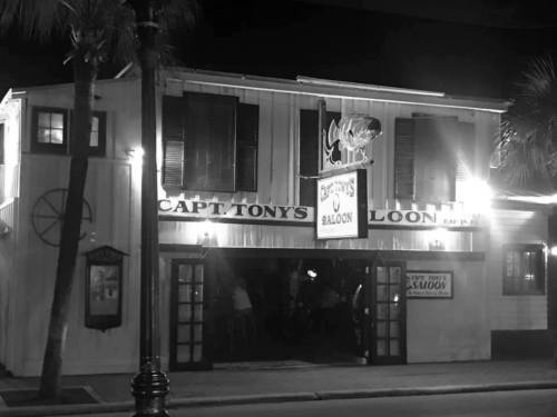 A nighttime view of Capt. Tony's Saloon, a lively bar with illuminated signage and a welcoming entrance.