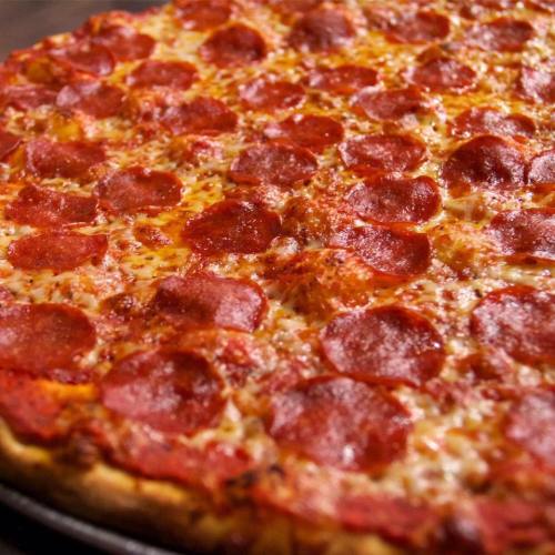 A close-up of a pepperoni pizza with melted cheese and a golden crust.