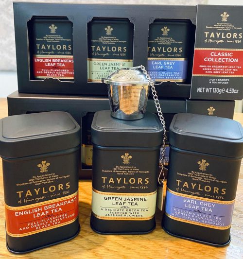 A display of Taylors tea tins, including English Breakfast, Green Jasmine, and Earl Grey, with a tea infuser.