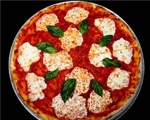 A large pizza topped with tomato sauce, mozzarella cheese, and fresh basil leaves.