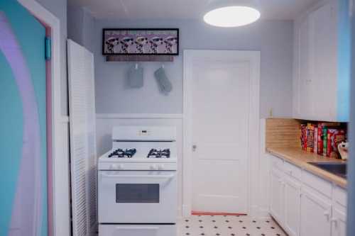 A bright kitchen featuring a white stove, wooden countertop, and colorful cereal boxes on the shelf.