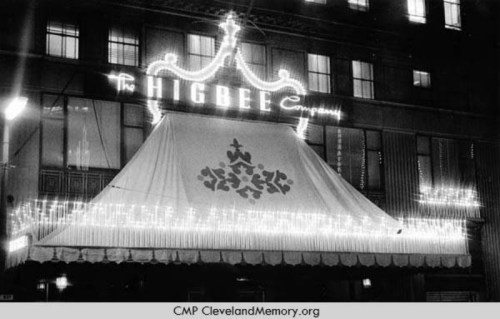 Historic black-and-white photo of the Higbee Company storefront, featuring decorative lights and an awning.