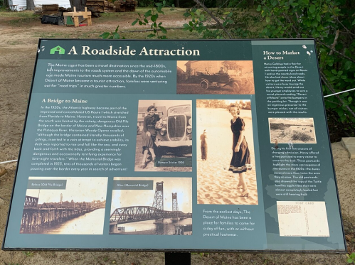 Sign about the history of the Maine highway, featuring a bridge and vintage car, discussing tourism and marketing.