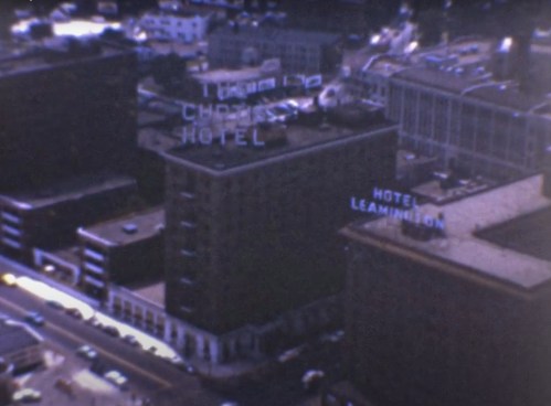 Aerial view of city buildings featuring "The Chris Hotel" and "Hotel Leamington" signs.