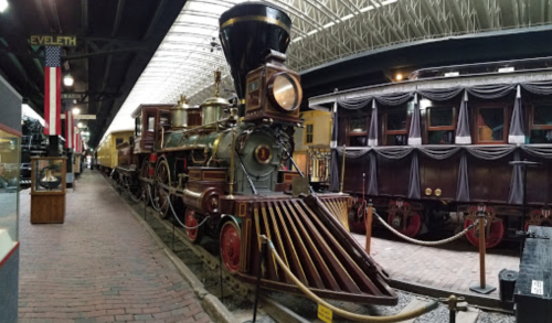A vintage steam locomotive displayed in a museum, showcasing intricate details and historical significance.