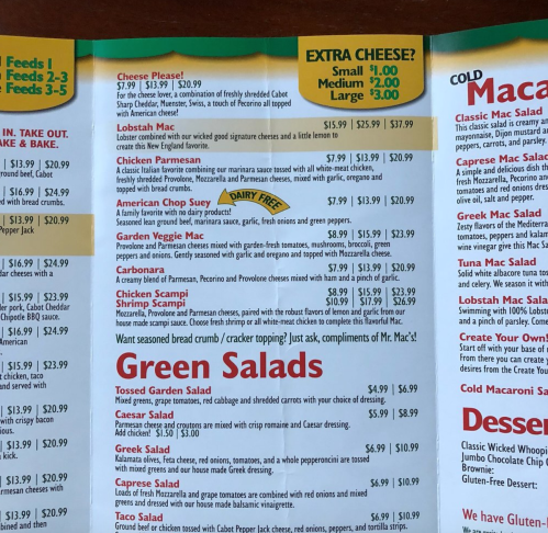 Menu page featuring various cheese dishes, salads, and prices for items like Lobster Mac and Cheese and Green Salads.